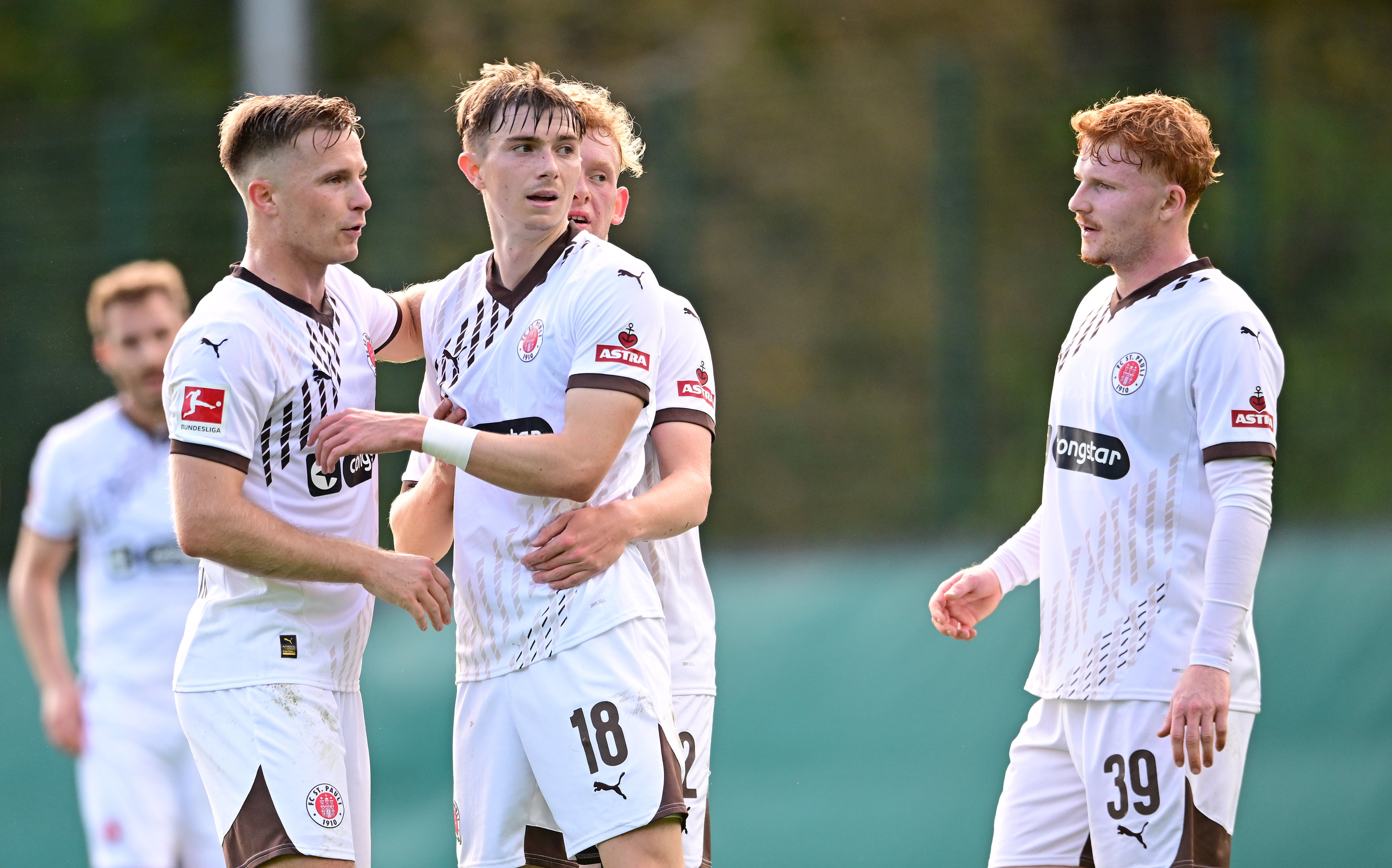 Scott Banks (No. 18) celebrates with teammates after this second goal against Hannover.