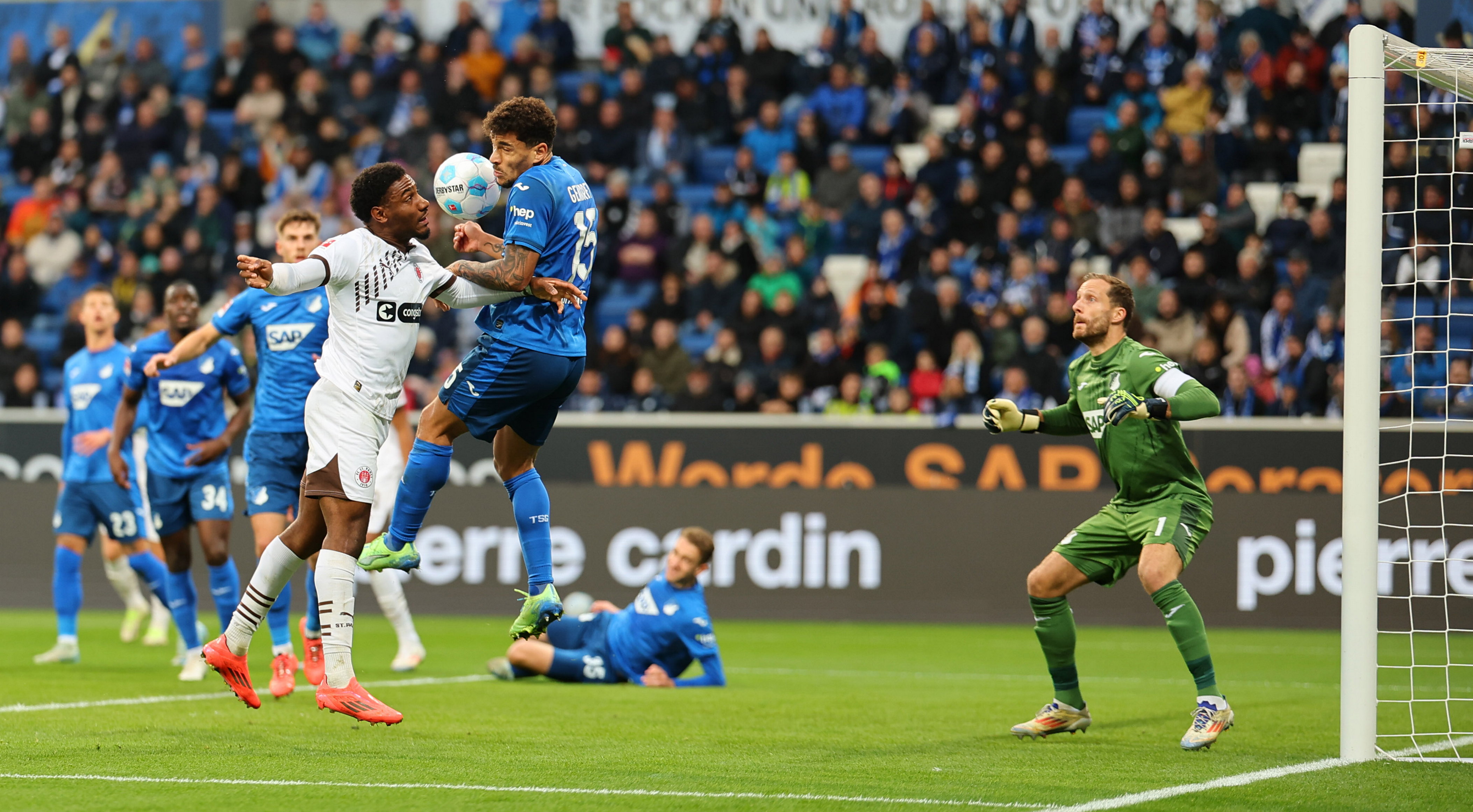 Goalscorer Oladapo Afolayan in an aerial duel with Hoffenheim's Valentin Gendrey.